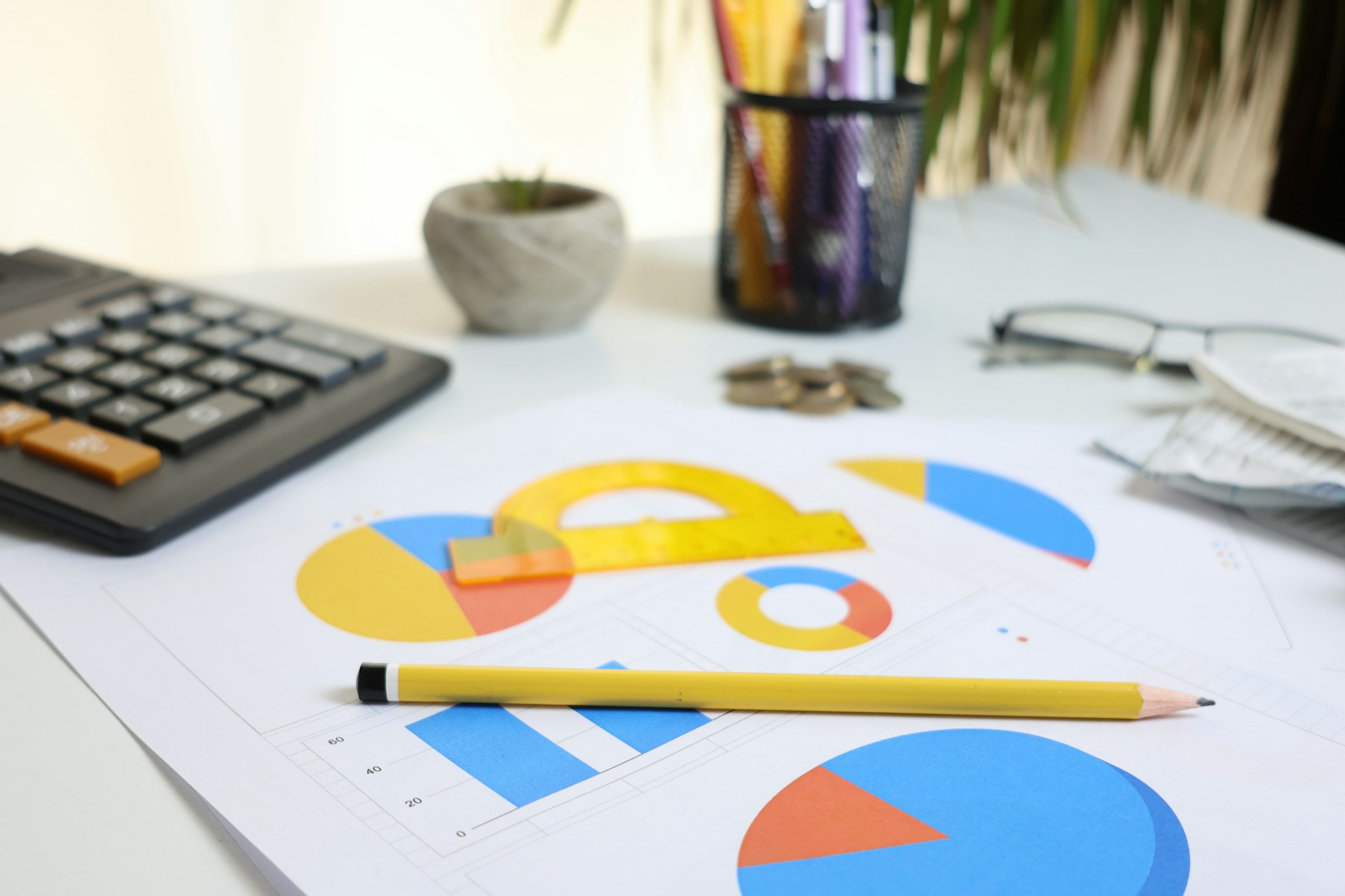 Desk with calculator, charts, and pencil